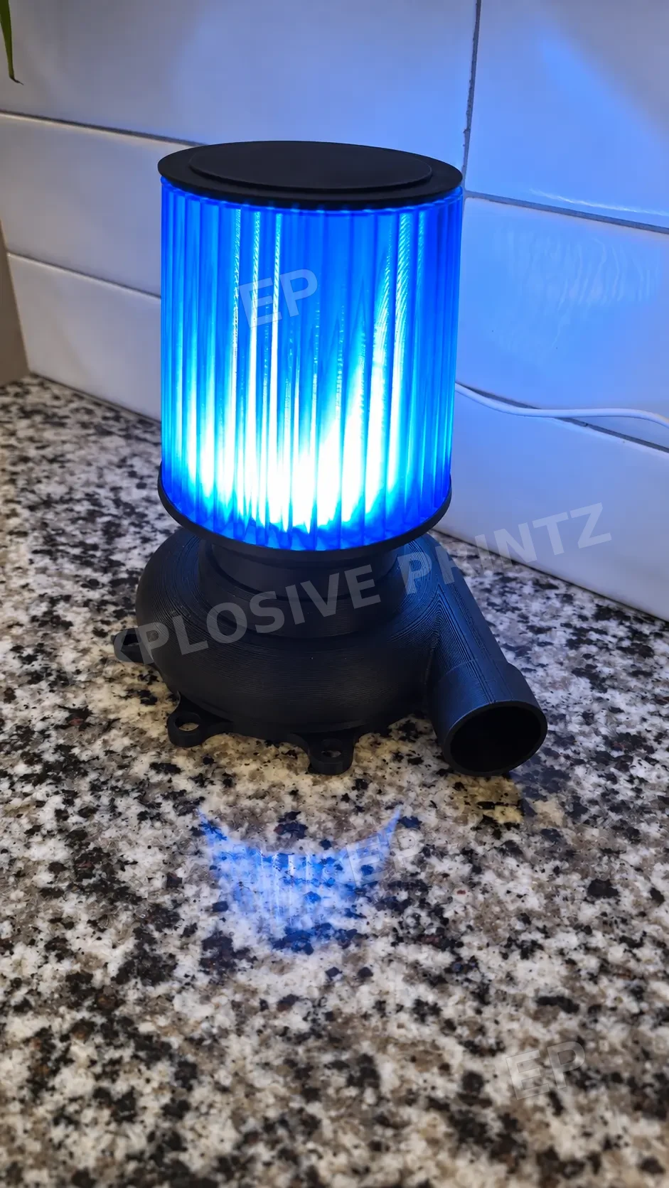Turbo Lamp illuminated blue, close-up of the black turbo-style base and ribbed shade