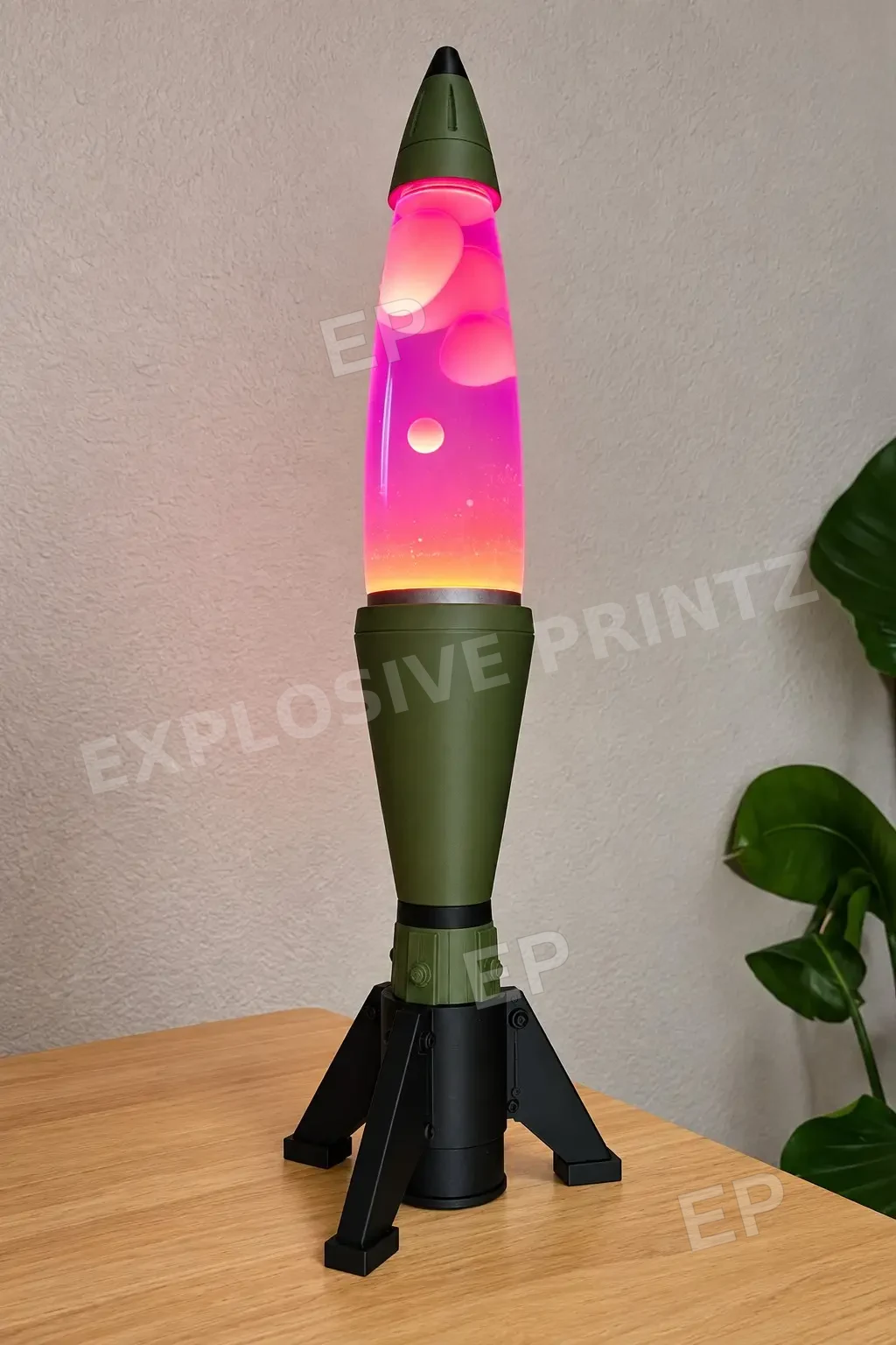 The Warhead, an olive green and black 3D printed lava lamp display on a desk